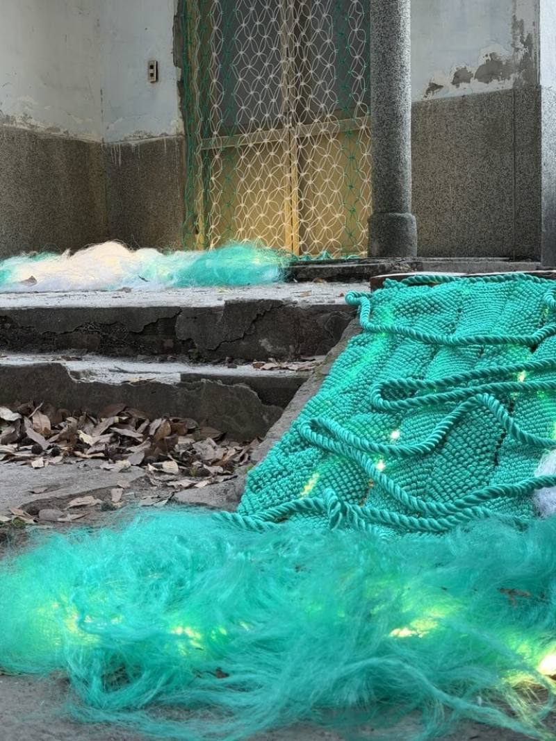 藝術家張晏慈參展「2026心村聚」活動，帶來裝置作品「如果海浪是離散，溫泉是撫慰」，以藍綠編織繩模擬海浪與泉水的流動，回應北投溫泉特色。