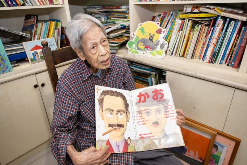 鄭明進手上的書是英國插畫家諾曼．梅森格（Norman Messenger）的知名童書《Famous faces》（日文版）圖說