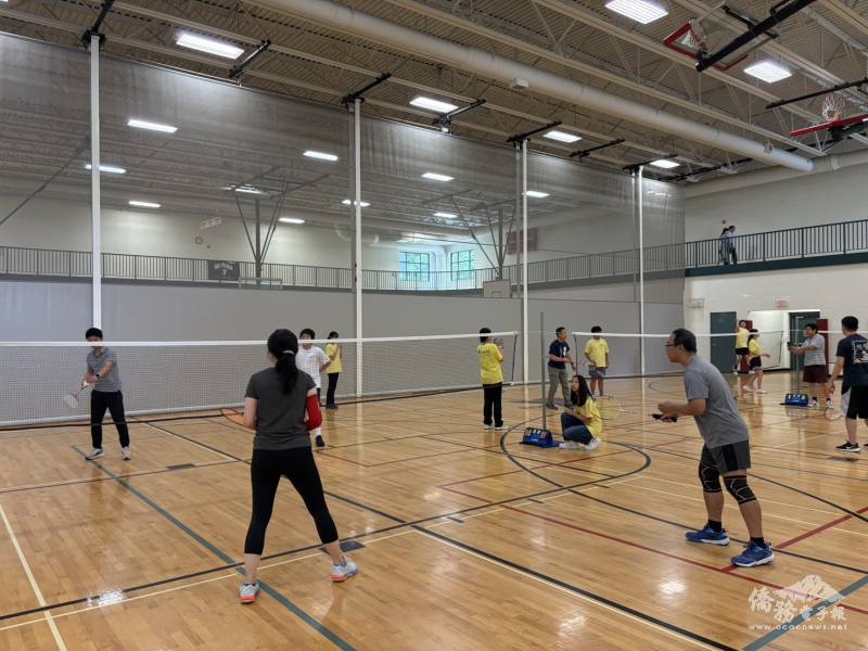 Teams in the badminton competition are focused on their tense game.