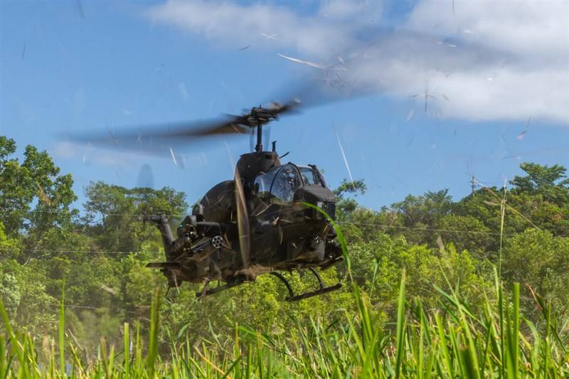 An Army Aviation and Training Command AH-1W Super Cobra attack helicopter flies low over a field in Tainan's Nanhua District during a deep-defense dispersal zone relocation drill on Wednesday, the third day of Taiwan's Joint Defense Exercises. Photo court