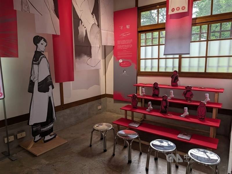 Exhibition items including a life-size manga character cutout, artwork banners and figurines on tiered shelves are displayed at the National Taiwan Museum of Comics in Taichung on Wednesday, a day before the opening of the "Taiwanese Lives of Ghosts in Co