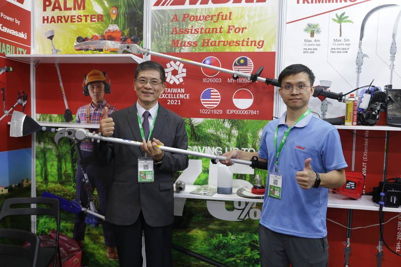 台灣農業機械工業同業公會理事長姚倍欽（左）在馬來西亞農業科技展展示台灣業者研發的油棕採收機具，盼透過省工、省力設備，因應當地農業缺工與技術升級，搶攻智慧農業需求。