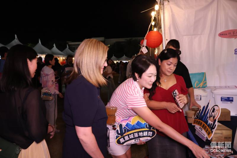 Phoenix Turnkey Solutions（PTS）執行長李美萱(中)向鳳凰城市長Kate Gallego(左)介紹臺北龍山寺的特色姻緣御守。